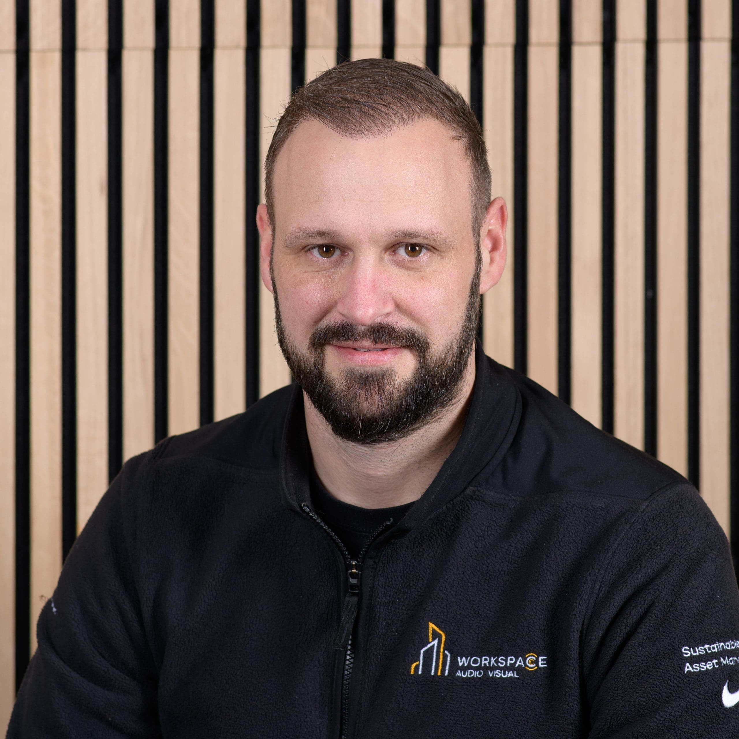 man with a beard wearing a black jacket